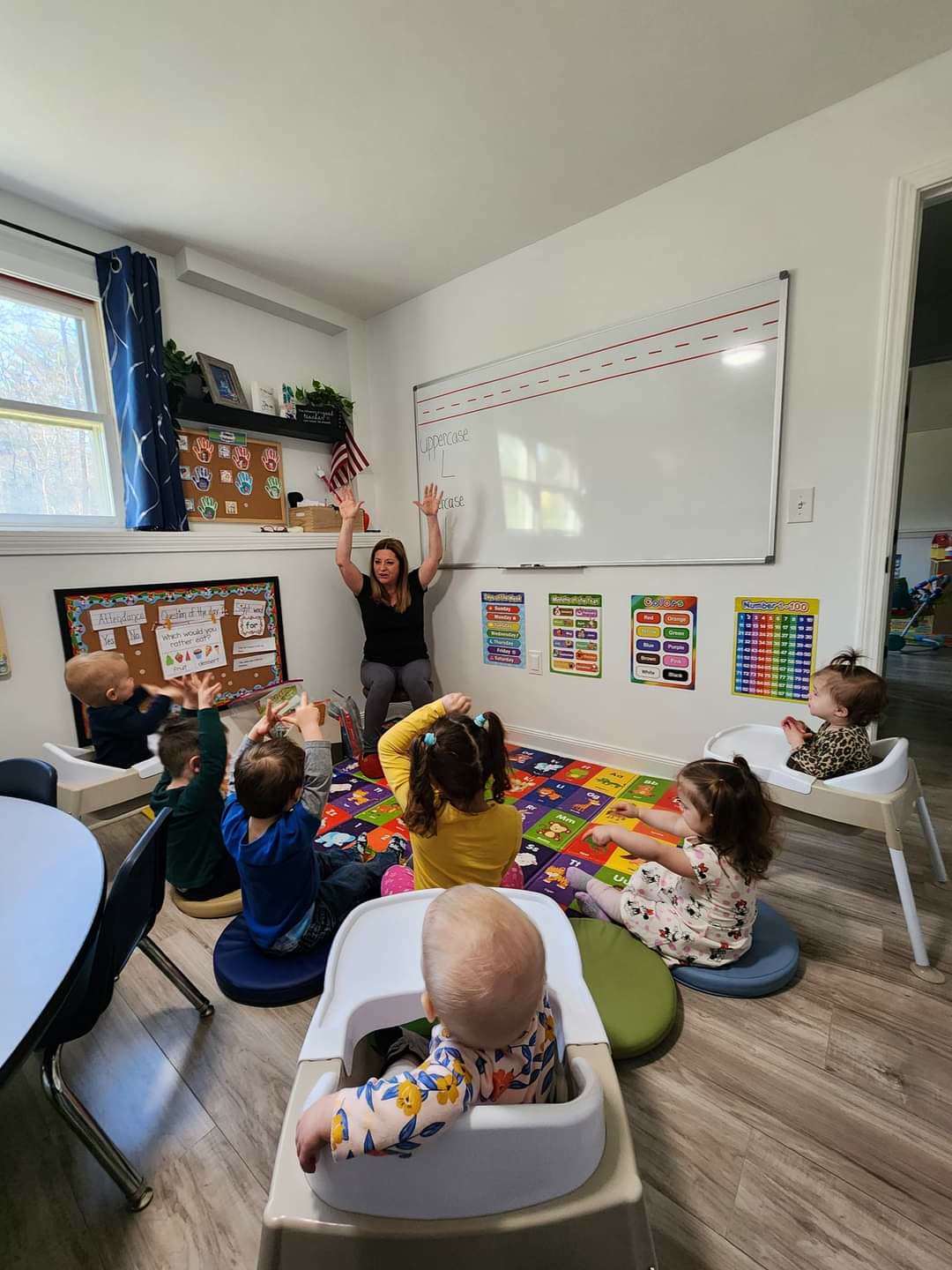 Children with hands raised during a lively circle time